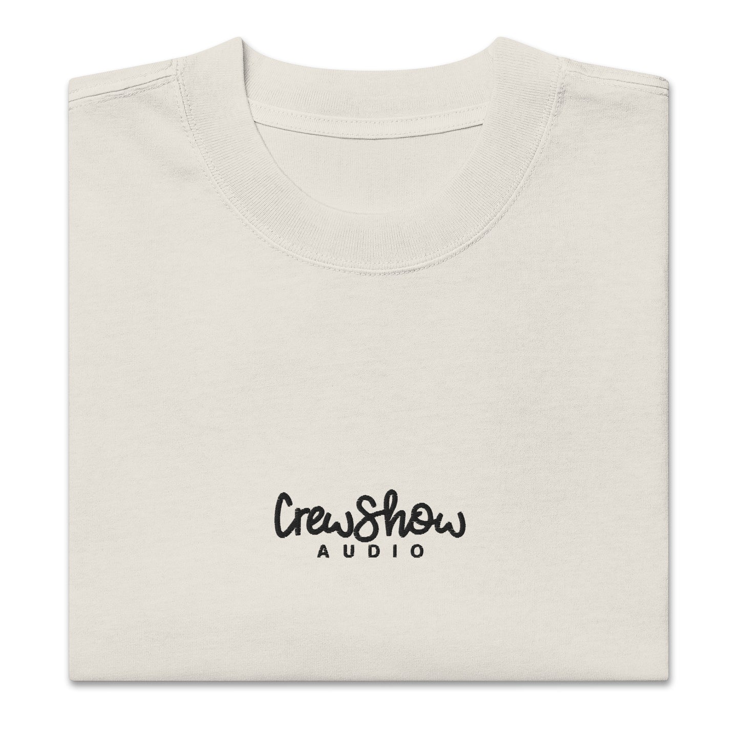 Crew Show Flow Script style embroidered t-shirt. Front view of folded bone coloured t-shirt which has Crew Show Audio embroidered on it.