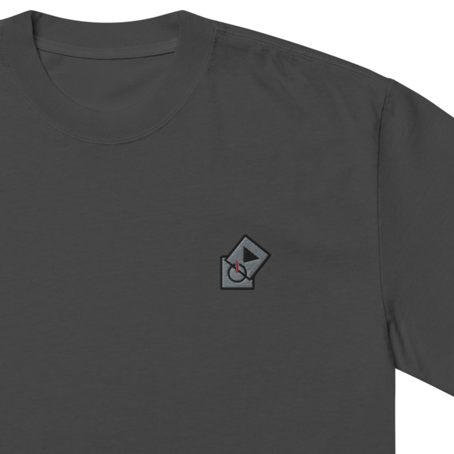 Power Play Audio Icons box fit t-shirt. Close up front view of a faded black t-shirt with an embroidered graphic of tech icons for power and play in the top left position.