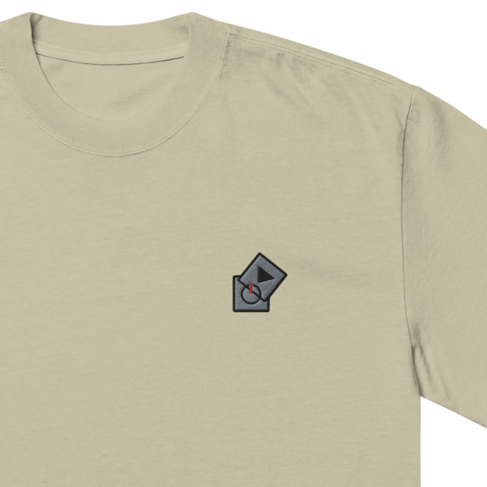 Power Play Audio Icons box fit t-shirt. Close up front view of a eucalyptus coloured t-shirt with an embroidered graphic of tech icons for power and play in the top left position.