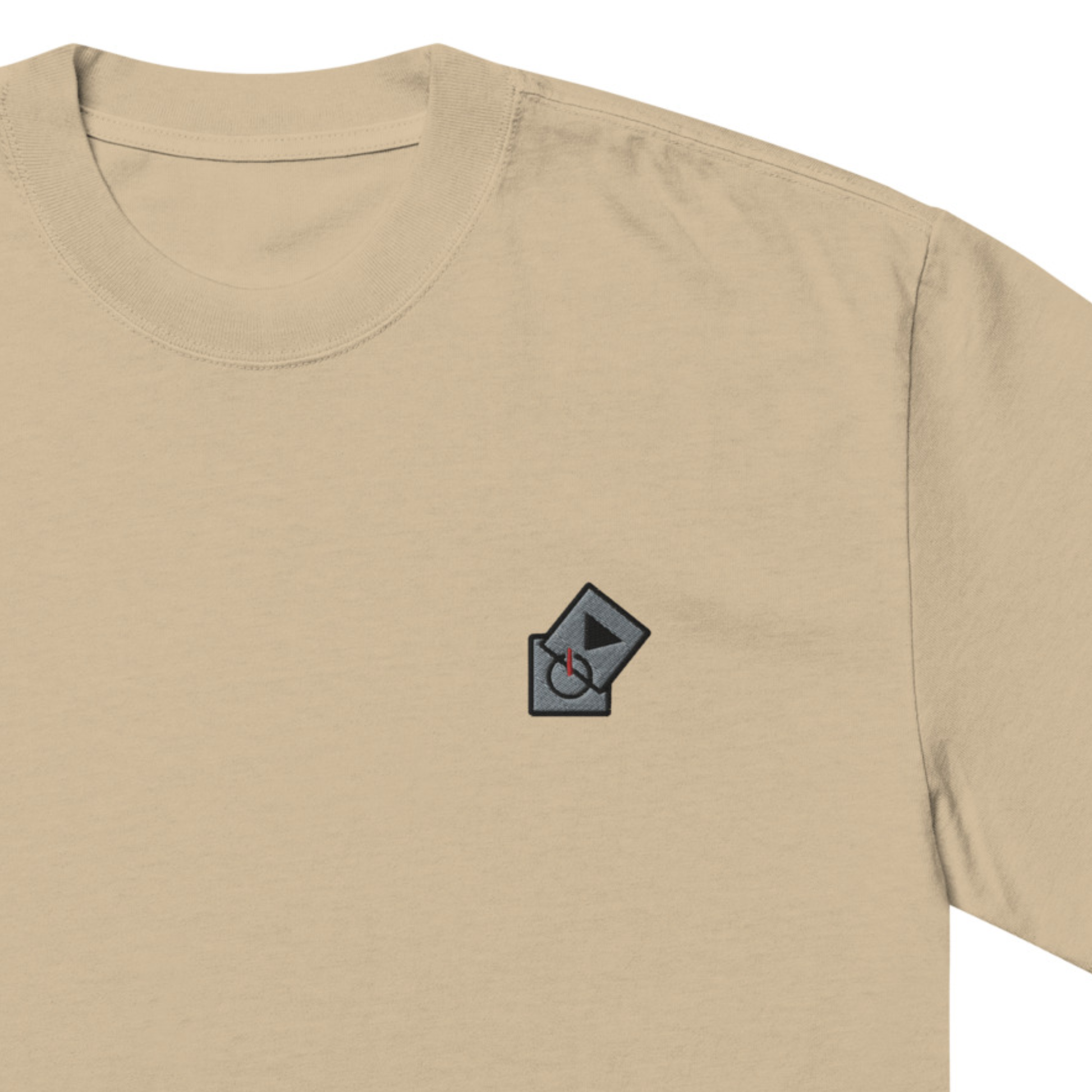 Power Play Audio Icons box fit t-shirt. Close up front view of a khaki coloured t-shirt with an embroidered graphic of tech icons for power and play in the top left position.