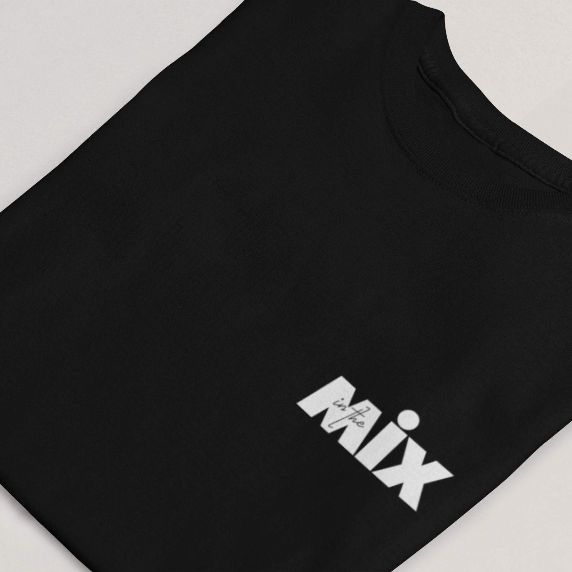 In the Mix 1 Sound mixer graphic t-shirt. Close up front view of folded black t-shirt with text on it that says MIX