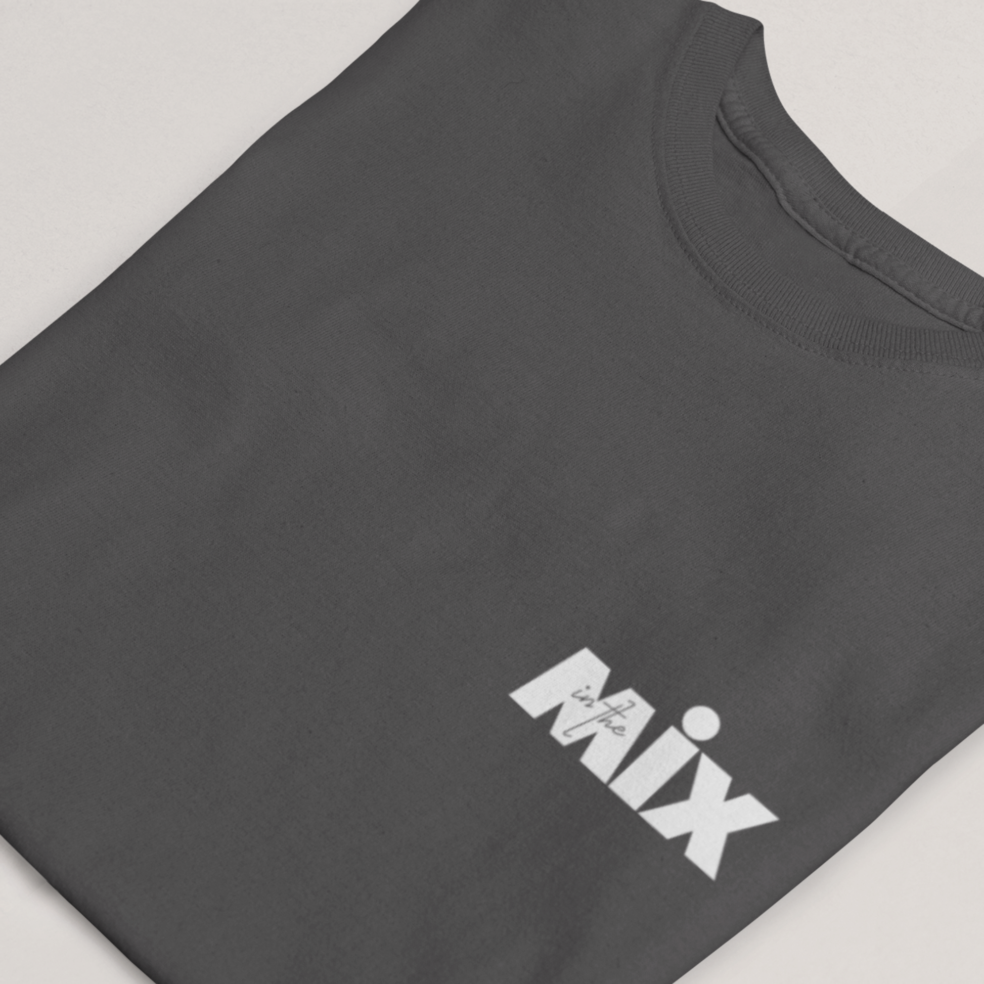 In the Mix 1 Sound mixer graphic t-shirt. Close up front view of folded grey t-shirt with text on it that says MIX