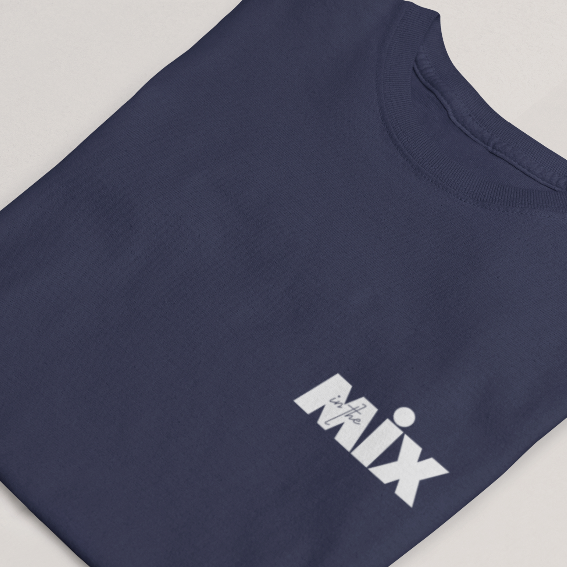 In the Mix 1 Sound mixer graphic t-shirt. Close up front view of folded navy t-shirt with text on it that says MIX