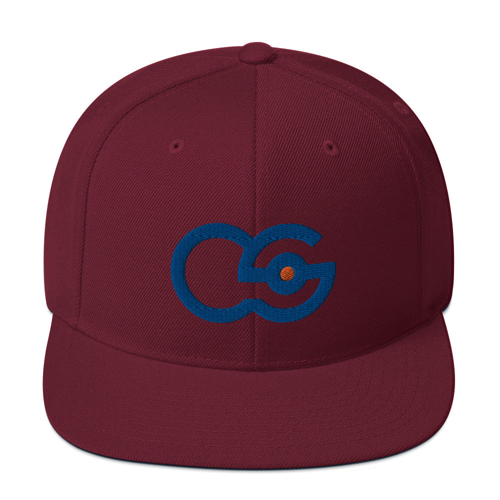 Crew Show logo snapback cap. Close up front view of maroon colour snapback cap with embroidered Crew Show logo on it.