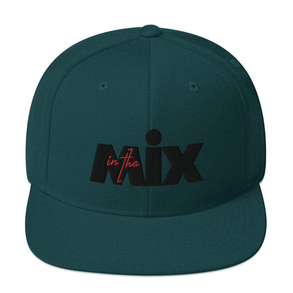 In The Mix embroidered snapback cap. Front view of green cap with embroidered text that says MIX.