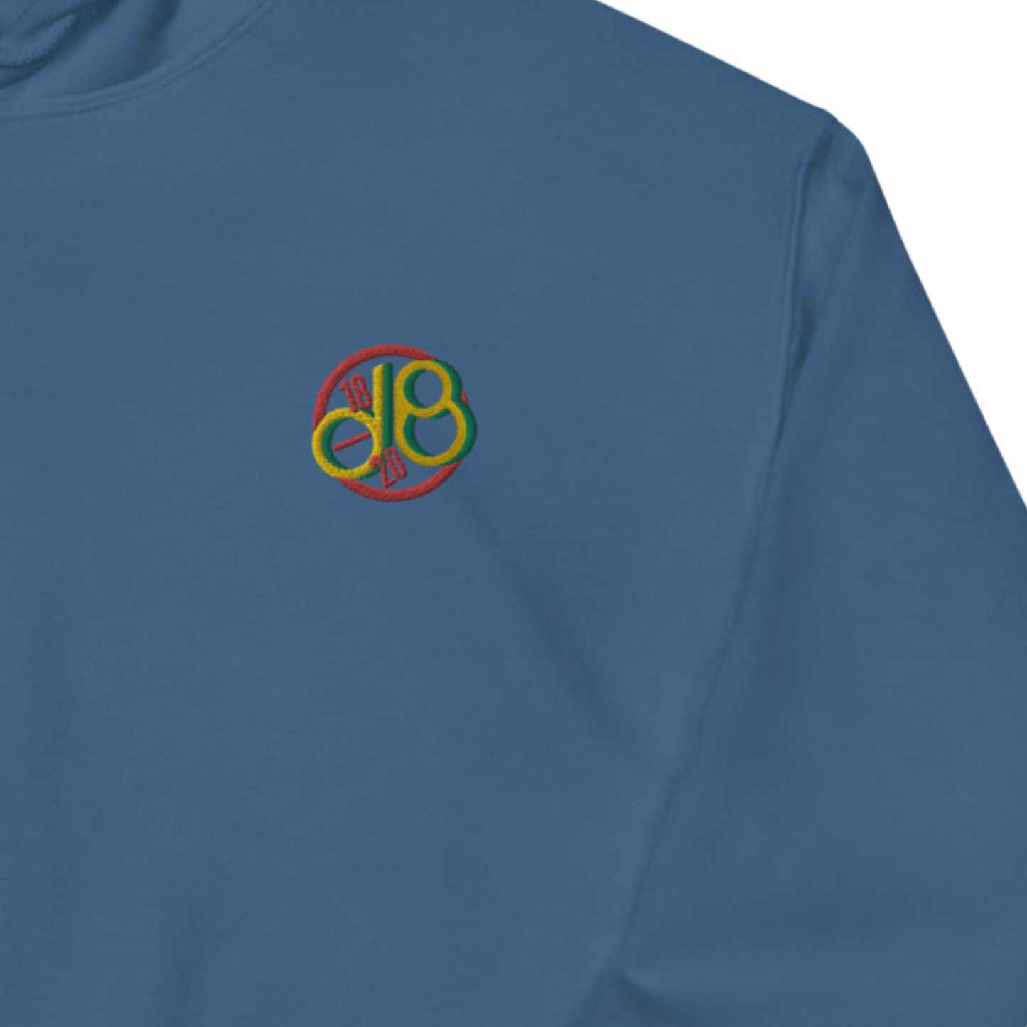 Full Scale Decibel embroidered hoodie. Close up front view of blue hoodie with embroidered letters d & B.