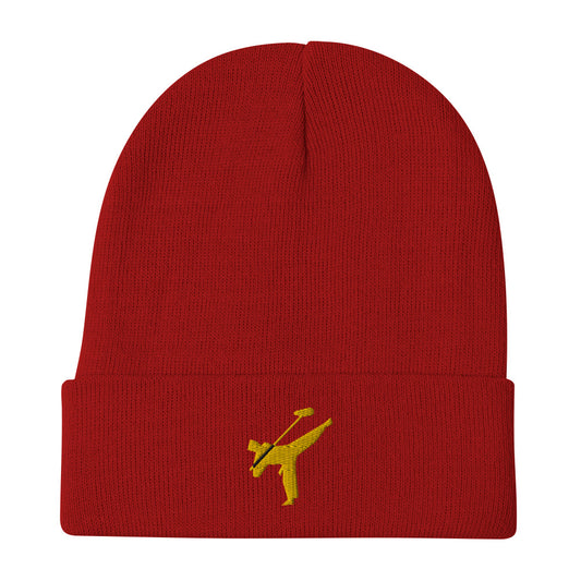 Art Form Gold boom op icon embroidered beanie. Front view of a red beanie with an embroidered graphic of a martial arts fighter.