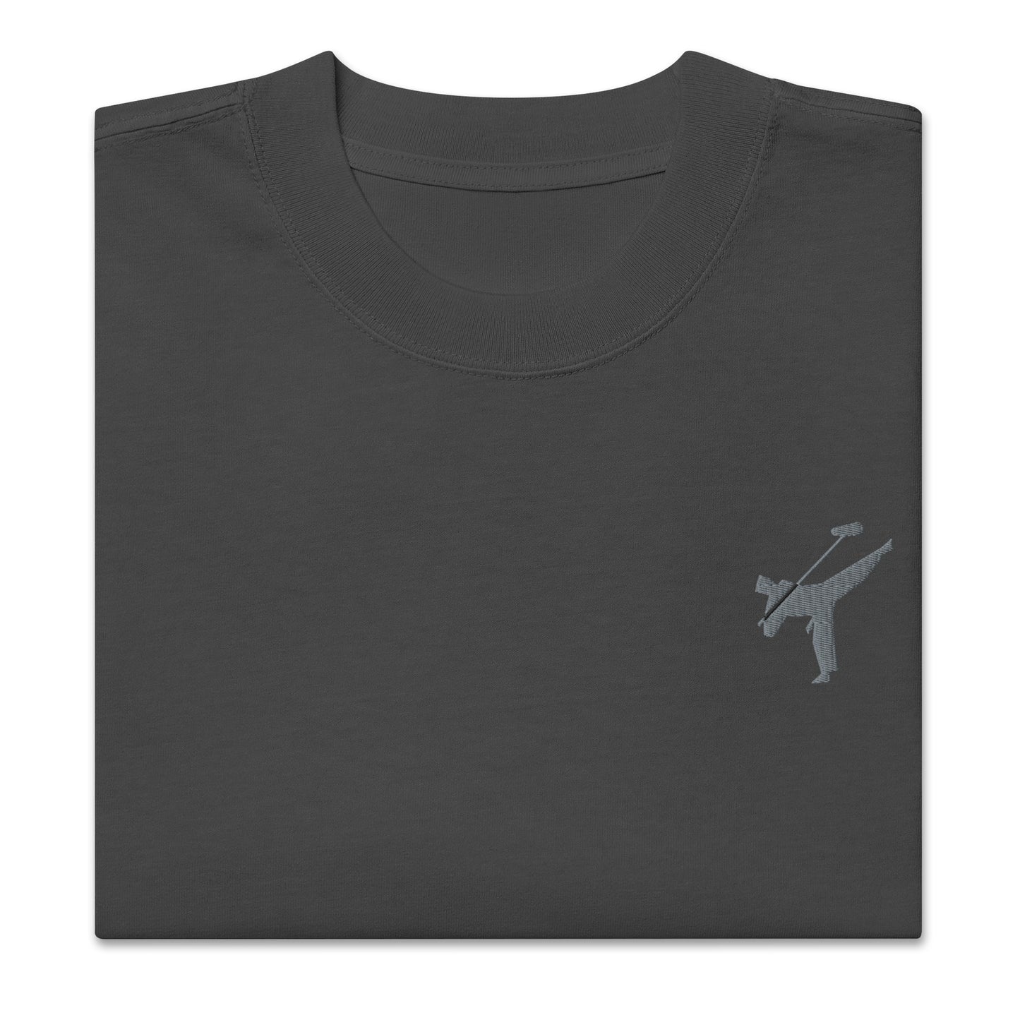 Art Form Boom Icon embroidered T-shirt, close up front view of folded faded black colour t-shirt with an embroidered martial arts boom operator in the top left.