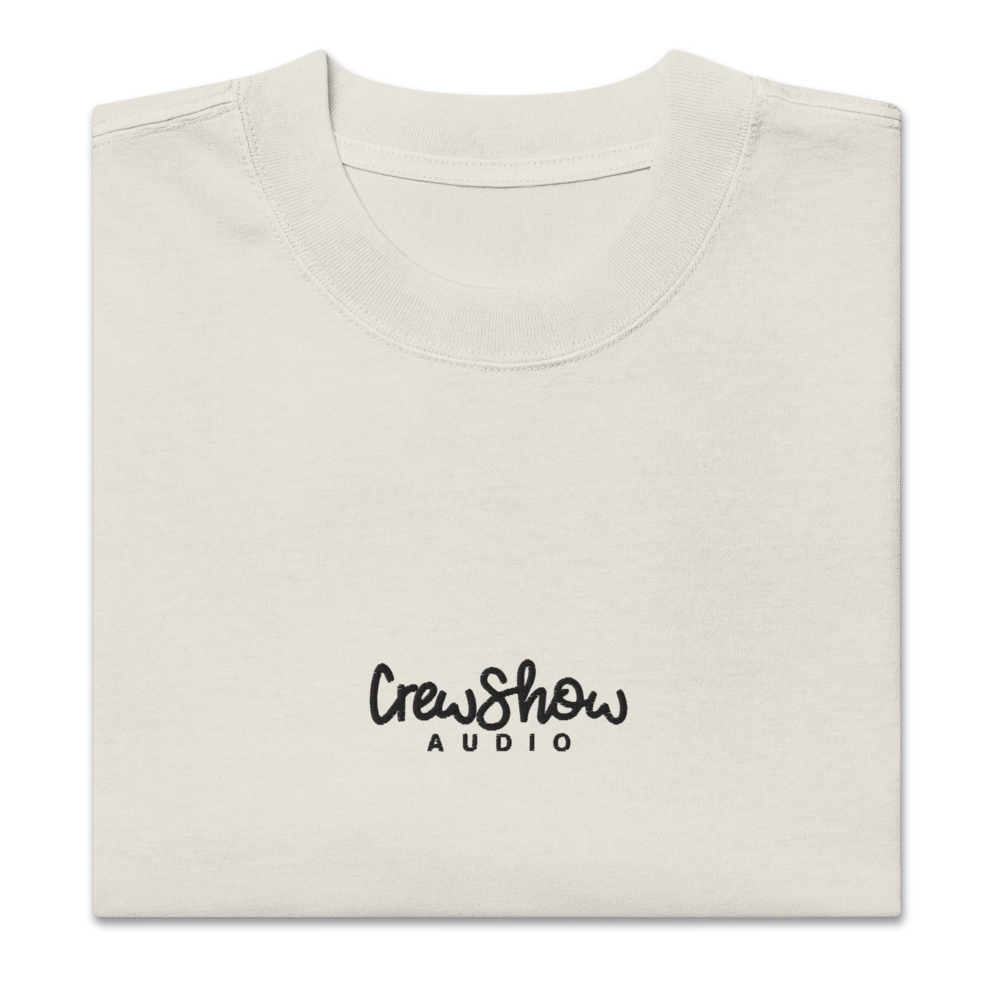 Crew Show Flow Script style embroidered t-shirt. Front view of folded  bone coloured t-shirt which has Crew Show Audio embroidered on it.