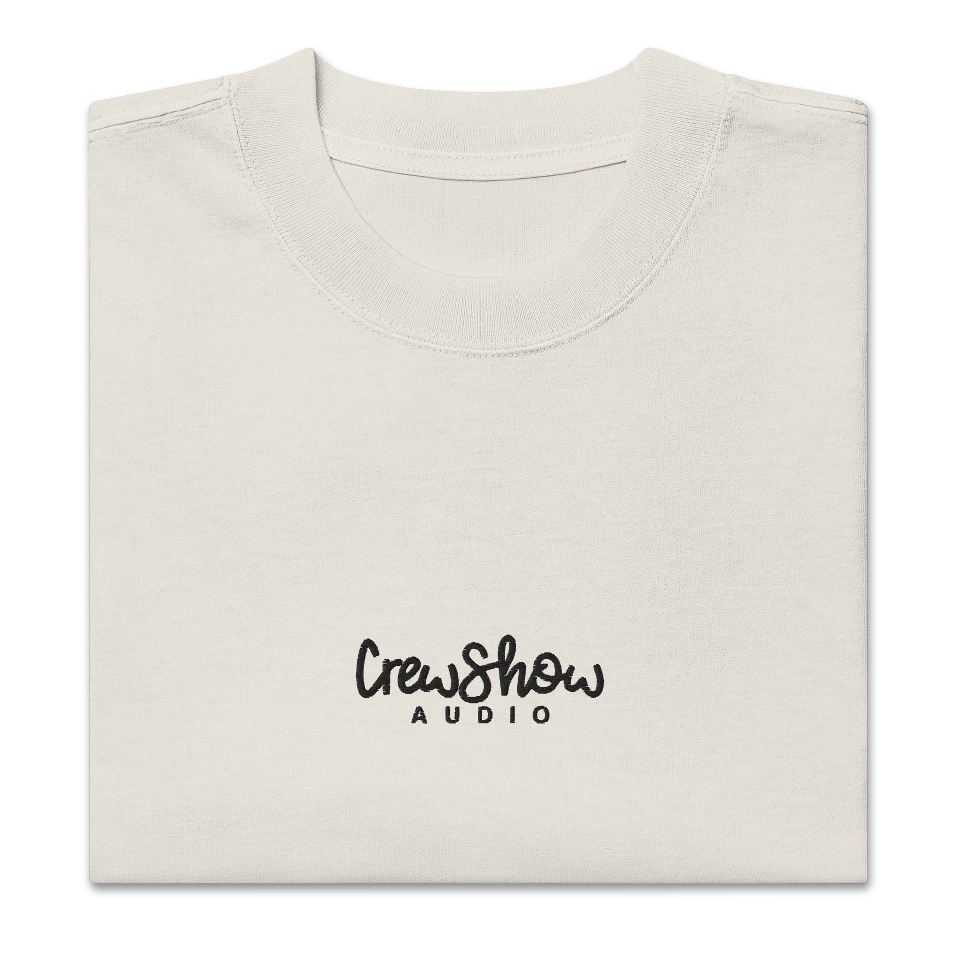 Crew Show Flow Script style embroidered t-shirt. Front view of folded  bone coloured t-shirt which has Crew Show Audio embroidered on it.