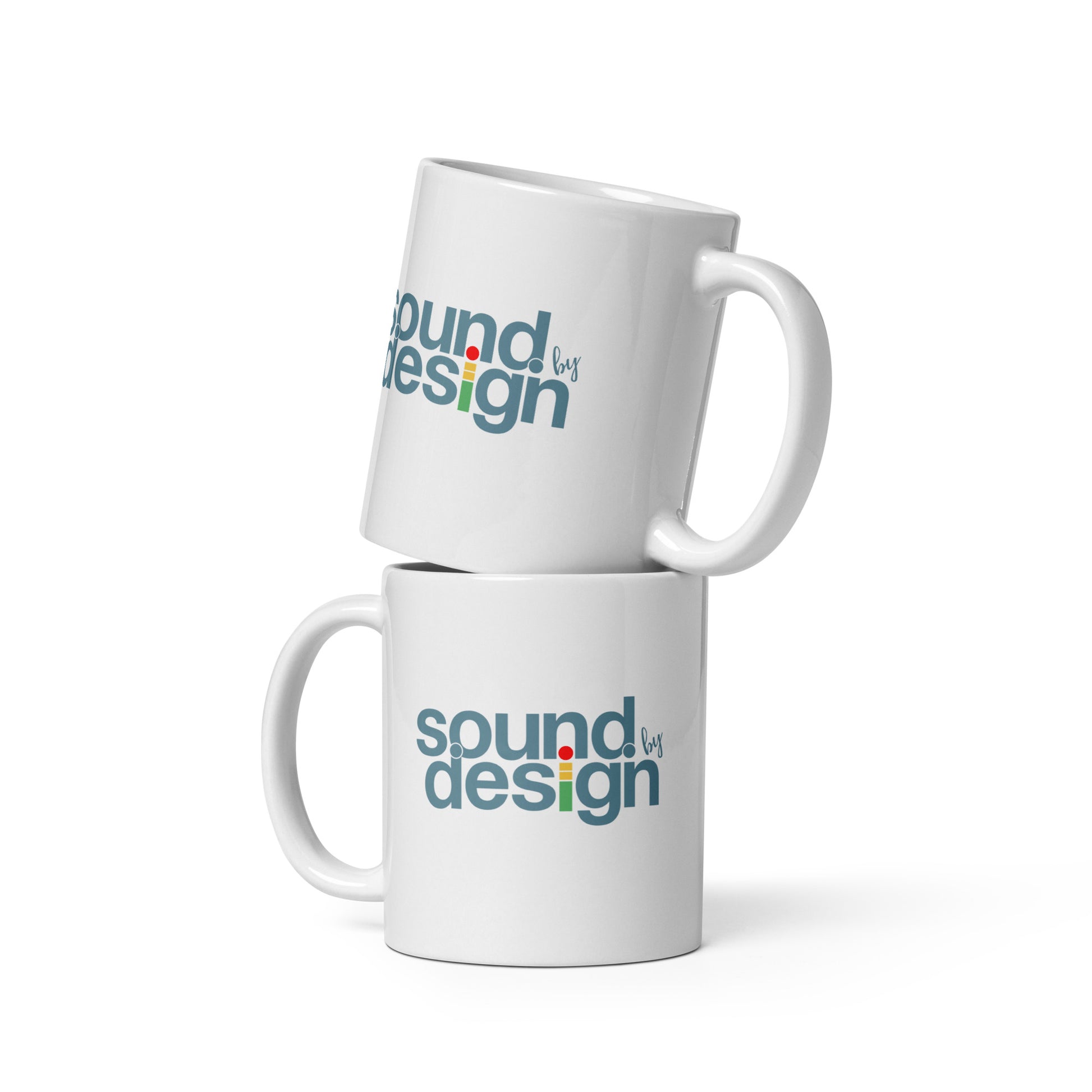 Sound by Design glossy white mug. Side view of 2 mugs one ontop of the other. On the mugs is a graphic that says Sound by Design.